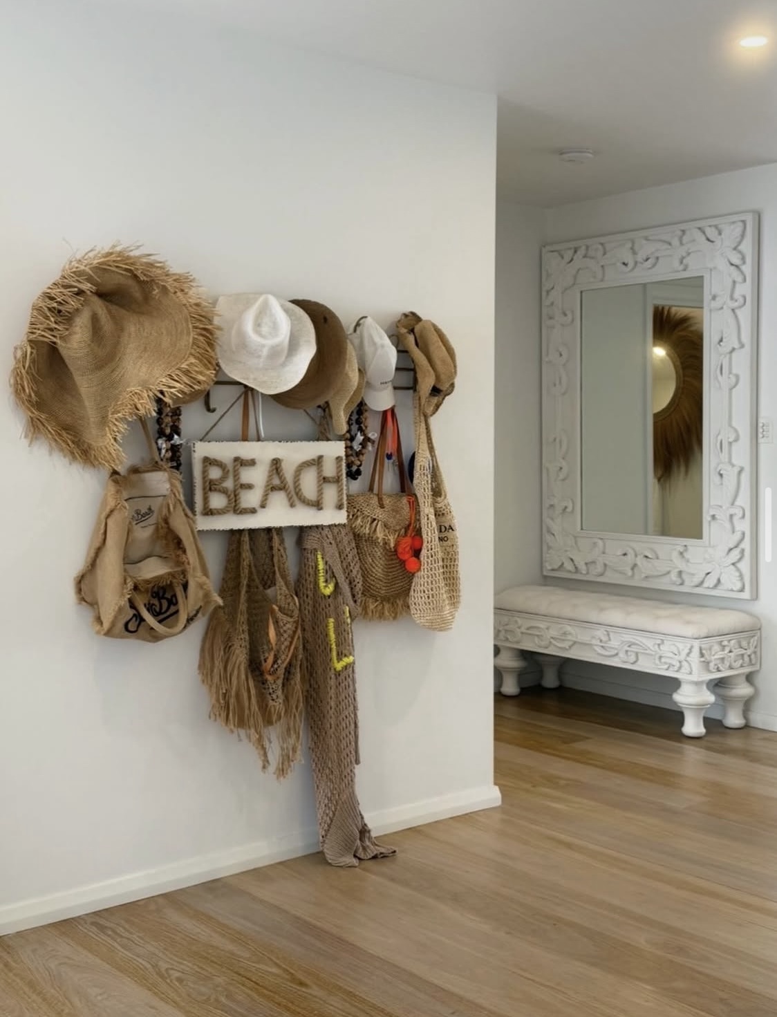 Beach gear wall rack with straw hats and bags