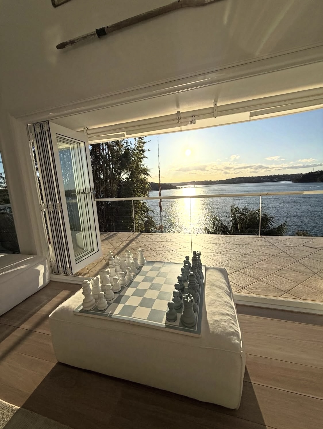 Chess board with golden sunset waterfront view