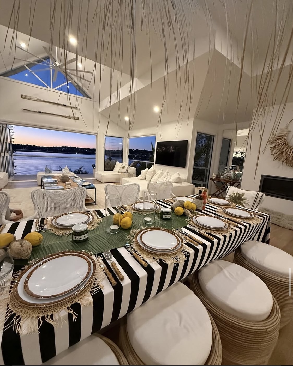 Styled long dining table with twilight ocean view