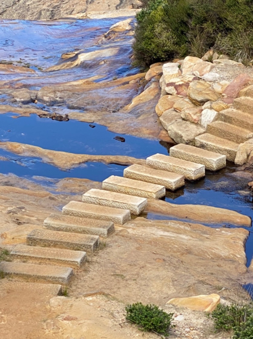 Sandstone stepping stones crossing a tidal creek in the Royal National Park